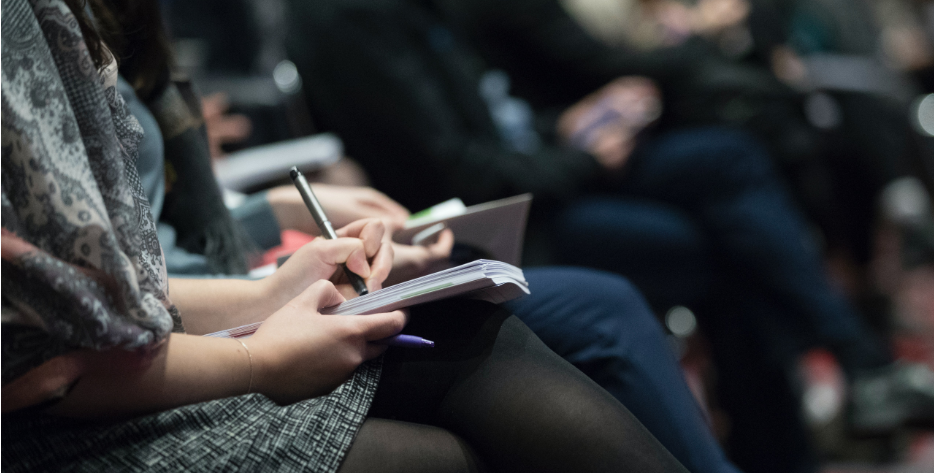 A woman taking notes on her lap